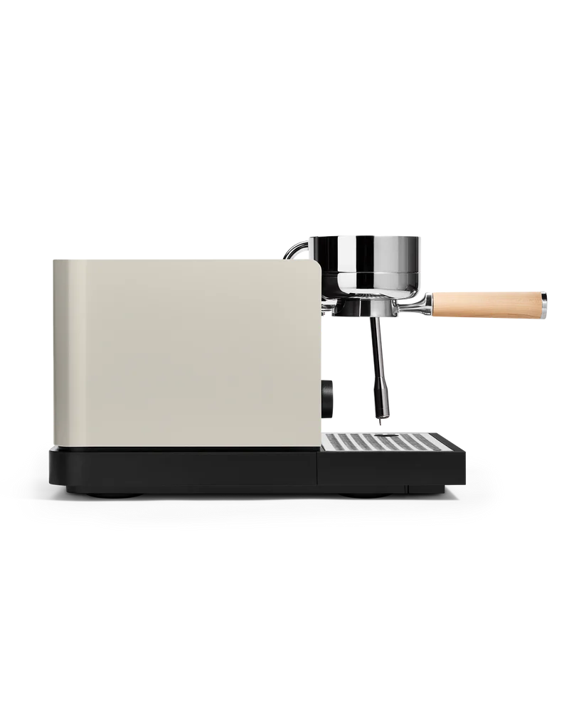 Fellow Espresso series 1 espresso machine in profile view with a sleek design and wooden handle.